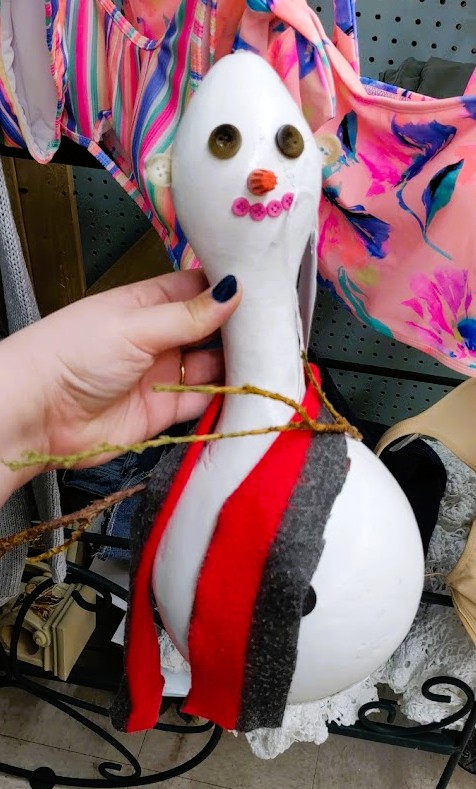 Poorly handmade... snowman? With button eyes and twigs for arms.